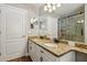 Updated bathroom with double granite vanity and modern shower with glass door at 369 Belhaven Falls Dr, Ocoee, FL 34761