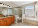 Bathroom featuring a glass shower, soaking tub, and double sinks at 369 Belhaven Falls Dr, Ocoee, FL 34761