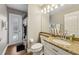 Bathroom featuring granite vanity, framed mirror and tiled floors at 369 Belhaven Falls Dr, Ocoee, FL 34761