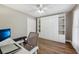 Bedroom features a large built-in closet, a ceiling fan, hardwood floors, and a cozy workspace at 369 Belhaven Falls Dr, Ocoee, FL 34761