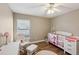 Bedroom featuring a crib and comfortable rocking chair at 369 Belhaven Falls Dr, Ocoee, FL 34761