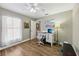 Bright bedroom features hardwood floors, a ceiling fan, and a cozy workspace with lots of natural light at 369 Belhaven Falls Dr, Ocoee, FL 34761