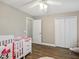Bright bedroom with a white crib and wood-look floors at 369 Belhaven Falls Dr, Ocoee, FL 34761