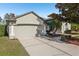 Charming home featuring a well-manicured yard, complemented by mature landscaping and a spacious two-car garage at 369 Belhaven Falls Dr, Ocoee, FL 34761