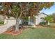 Charming single-story home with mature landscaping, including a large tree and well-manicured lawn at 369 Belhaven Falls Dr, Ocoee, FL 34761