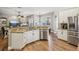Open concept kitchen with granite countertops, stainless steel appliances, and backyard views at 369 Belhaven Falls Dr, Ocoee, FL 34761