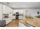 Spacious kitchen with granite countertops, stainless steel appliances, and white cabinetry at 369 Belhaven Falls Dr, Ocoee, FL 34761
