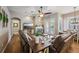 Spacious living room featuring a stone fireplace and double french doors to backyard at 369 Belhaven Falls Dr, Ocoee, FL 34761