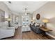 Cozy living room featuring hardwood floors, a ceiling fan, and a glimpse of the outdoor pool area at 369 Belhaven Falls Dr, Ocoee, FL 34761