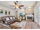 Cozy living room with stone fireplace, ceiling fan and ample seating at 369 Belhaven Falls Dr, Ocoee, FL 34761
