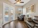 Cozy room featuring wood floors, comfortable seating, and sliding glass doors leading to a pool area at 369 Belhaven Falls Dr, Ocoee, FL 34761
