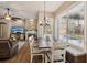 Open living space featuring a dining table, a fireplace and a view of the backyard at 369 Belhaven Falls Dr, Ocoee, FL 34761