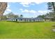 Beautiful backyard boasts a screened-in porch, a plush lawn and shady mature trees at 4154 Equestrian Ln, Windermere, FL 34786