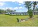 A scenic backyard features a fire pit, mature trees and a screened-in porch for enjoying the outdoors at 4154 Equestrian Ln, Windermere, FL 34786