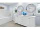 Bathroom featuring double sinks, a vanity, modern fixtures, and a separate tub at 4154 Equestrian Ln, Windermere, FL 34786