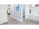 Bright bathroom featuring tile flooring, a soaking tub, and view into an adjacent room at 4154 Equestrian Ln, Windermere, FL 34786