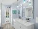 Bathroom features a double sink vanity and a door that leads to a pool area at 4154 Equestrian Ln, Windermere, FL 34786