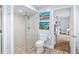 Modern bathroom with glass enclosed shower, tiled floor, and artistic decor at 4154 Equestrian Ln, Windermere, FL 34786