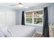 Bright bedroom with ceiling fan, sliding closet doors, and a window view of the pool at 4154 Equestrian Ln, Windermere, FL 34786
