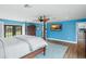 Bedroom boasts a four-poster bed, wood floors, a TV, and access to the backyard at 4154 Equestrian Ln, Windermere, FL 34786