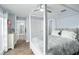 Bright bedroom with a four-poster bed, closet and a glimpse into an en-suite bathroom at 4154 Equestrian Ln, Windermere, FL 34786