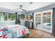 Comfortable bedroom with pool views, wooden floors, and ceiling fan at 4154 Equestrian Ln, Windermere, FL 34786