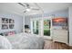 Bedroom boasts a four-poster bed, TV, and a window offering a pleasant outdoor view at 4154 Equestrian Ln, Windermere, FL 34786