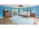 Primary bedroom with a four-poster bed, wood floors, and ample natural light at 4154 Equestrian Ln, Windermere, FL 34786