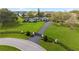 A well-maintained estate features a long driveway, a gated entry and mature trees for privacy at 4154 Equestrian Ln, Windermere, FL 34786
