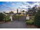 Gated driveway leading to an expansive single story home with a lush, well-manicured front lawn at 4154 Equestrian Ln, Windermere, FL 34786