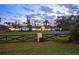 Gated driveway leading to an expansive single story home with a lush, well-manicured front lawn at 4154 Equestrian Ln, Windermere, FL 34786