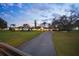 Expansive single story home featuring a circular driveway and lush, well-manicured front lawn at 4154 Equestrian Ln, Windermere, FL 34786