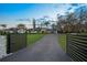 Long, sprawling single story home with black driveway and large front yard at 4154 Equestrian Ln, Windermere, FL 34786
