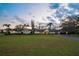 Picturesque home featuring a large front lawn, mature trees, and an inviting entrance at 4154 Equestrian Ln, Windermere, FL 34786