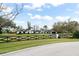 Stunning single-story home with manicured lawn, mature trees, and classic architectural details at 4154 Equestrian Ln, Windermere, FL 34786