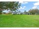 Elegant home with a vast green lawn, beautiful landscaping, and a circular driveway at 4154 Equestrian Ln, Windermere, FL 34786