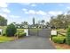 Impressive gated entrance leading to a stunning home, with meticulously maintained landscaping at 4154 Equestrian Ln, Windermere, FL 34786