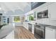 Well-lit kitchen with white cabinetry, stainless steel appliances, and a large sink at 4154 Equestrian Ln, Windermere, FL 34786
