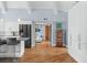 Open kitchen with a breakfast bar island, stainless steel appliances, and hardwood floors in an open floorplan at 4154 Equestrian Ln, Windermere, FL 34786