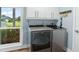 Modern laundry room with new washer and dryer and a window with a yard view at 4154 Equestrian Ln, Windermere, FL 34786