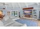 Coastal-themed living room with white vaulted ceilings, a blue rug, and a modern entertainment center at 4154 Equestrian Ln, Windermere, FL 34786