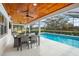 Screened lanai with a dining set, ceiling fans and a pool view at 4154 Equestrian Ln, Windermere, FL 34786