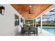 Covered patio with a dining table and chairs overlooking a screened pool at 4154 Equestrian Ln, Windermere, FL 34786