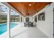 Back patio with a dining set, ceiling fans and a view of the pool at 4154 Equestrian Ln, Windermere, FL 34786