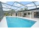 A large pool with a screened enclosure, string lights and a covered patio are perfect for outdoor living at 4154 Equestrian Ln, Windermere, FL 34786