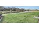 Expansive backyard with lush green grass and serene waterfront views at 4298 Campsite Loop, Orlando, FL 32824
