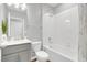 Well-lit bathroom featuring tile flooring, a single sink vanity, and a tub/shower combo at 4298 Campsite Loop, Orlando, FL 32824