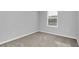 Bright bedroom with neutral walls and a large window at 4298 Campsite Loop, Orlando, FL 32824