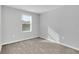 Bedroom featuring plush carpeting, neutral grey walls, and a window for natural light at 4298 Campsite Loop, Orlando, FL 32824