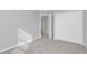 Bedroom featuring plush carpeting, neutral grey walls, and a view to an ensuite bathroom and walk in closet at 4298 Campsite Loop, Orlando, FL 32824